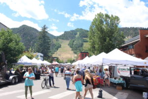 Saturday Farmers Market in Aspen, Colorado. View of Aspen Mountain in the background.