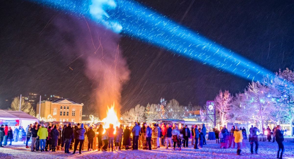 Night time shot of people gathered around a bonfire celebrating New Year's in Aspen, Colorado