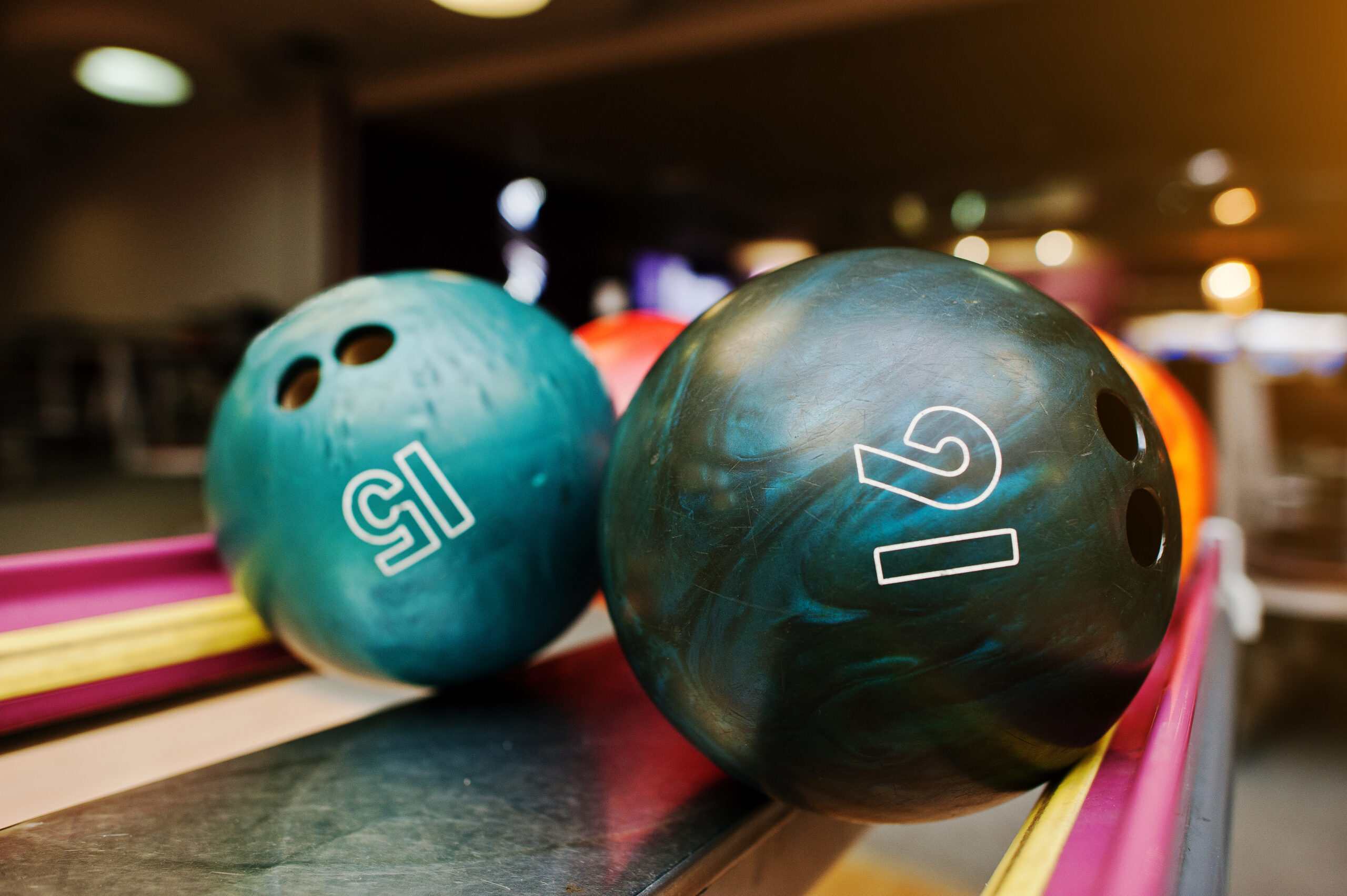 Two colored bowling balls of number 16 and 15