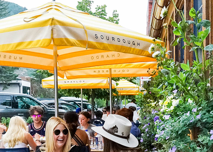 Yellow and white striped umbrellas on an outdoor patio during summer in Aspen