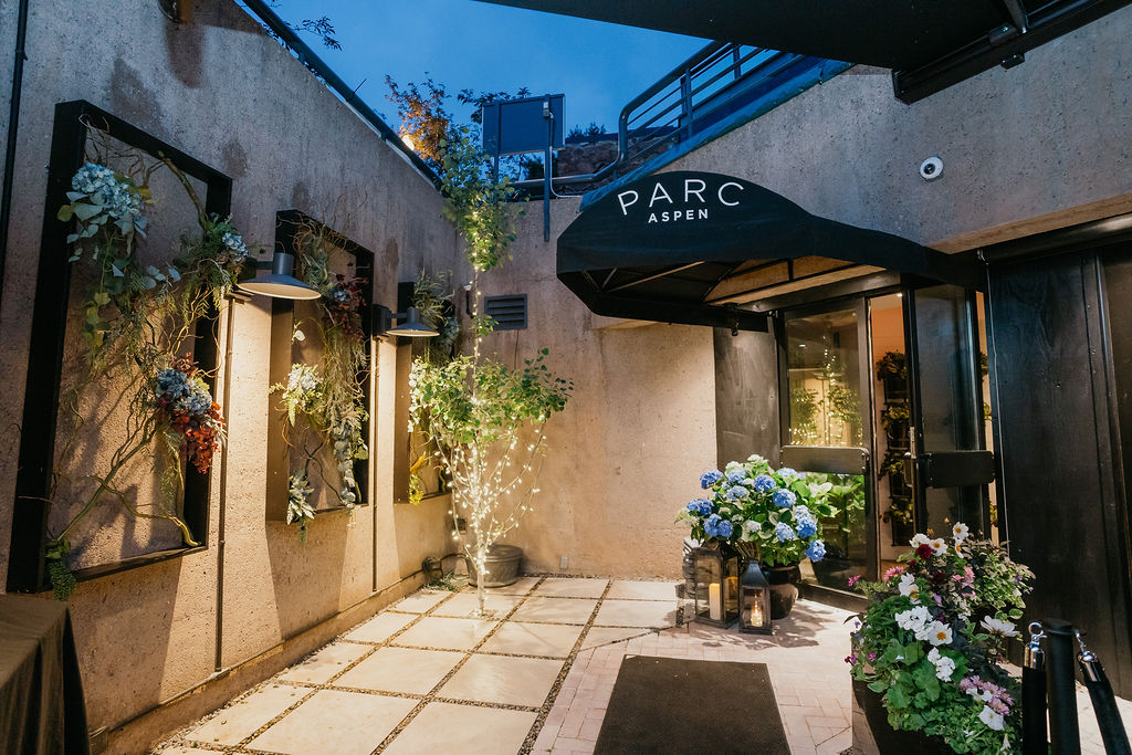 An outdoor patio at Parc Aspen with summer flowers