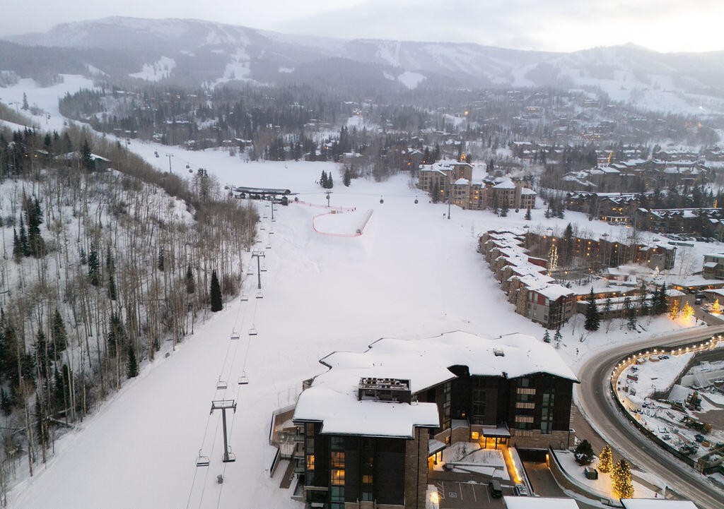 Aspen village in winter with snow-covered streets at sunset