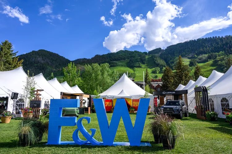 Food & Wine logo in front of Aspen Mountain in Wagner Park, Aspen Colorado