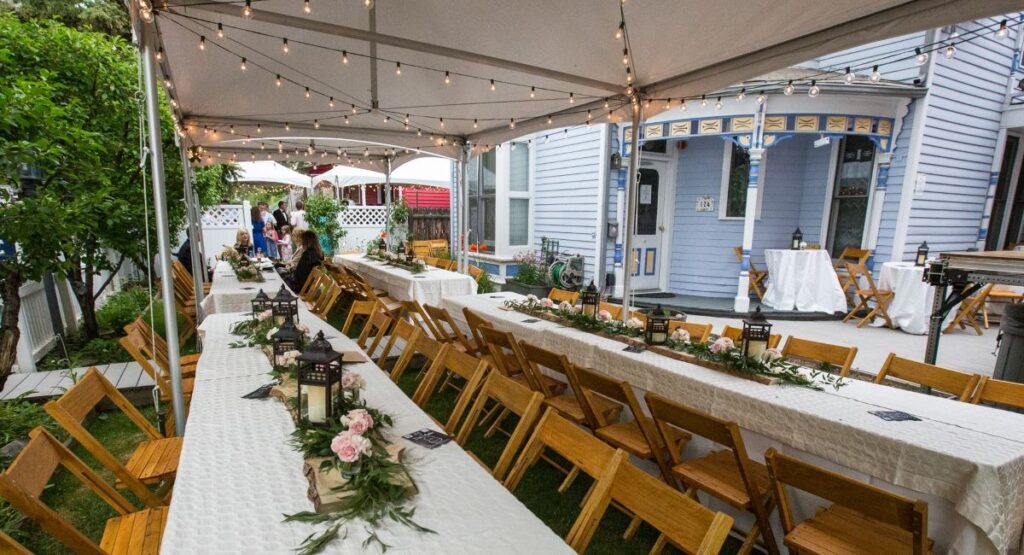Outdoor wedding setup on an Aspen estate with a tent and tables visible in the staging area