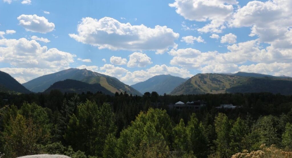 Aspen's Mountain landscape in Summer with lush green trees in the foreground.