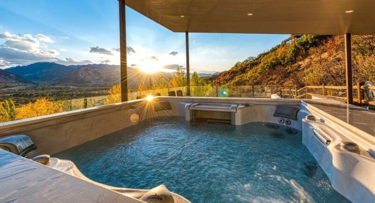 A view of the Aspen landscape during sunset from a luxury hot tub on a patio of a Red Mountain vacation rental